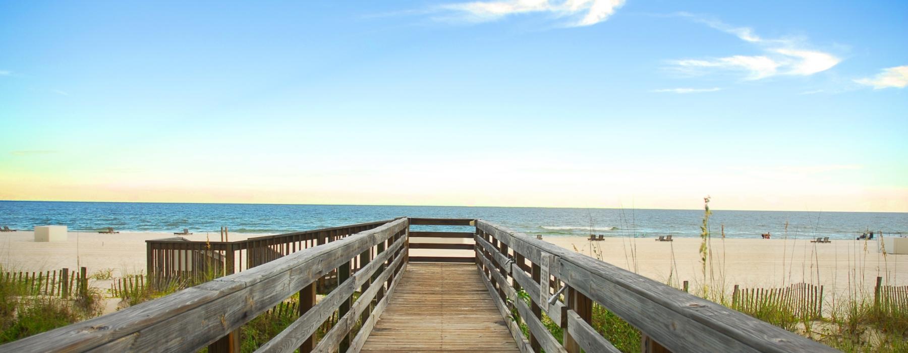 a wooden bridge to water