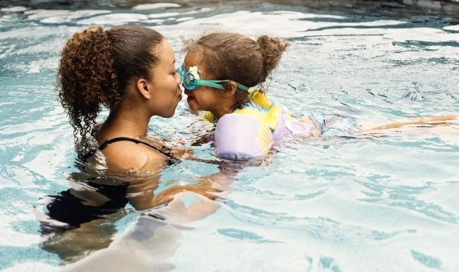 a person and a baby in a pool