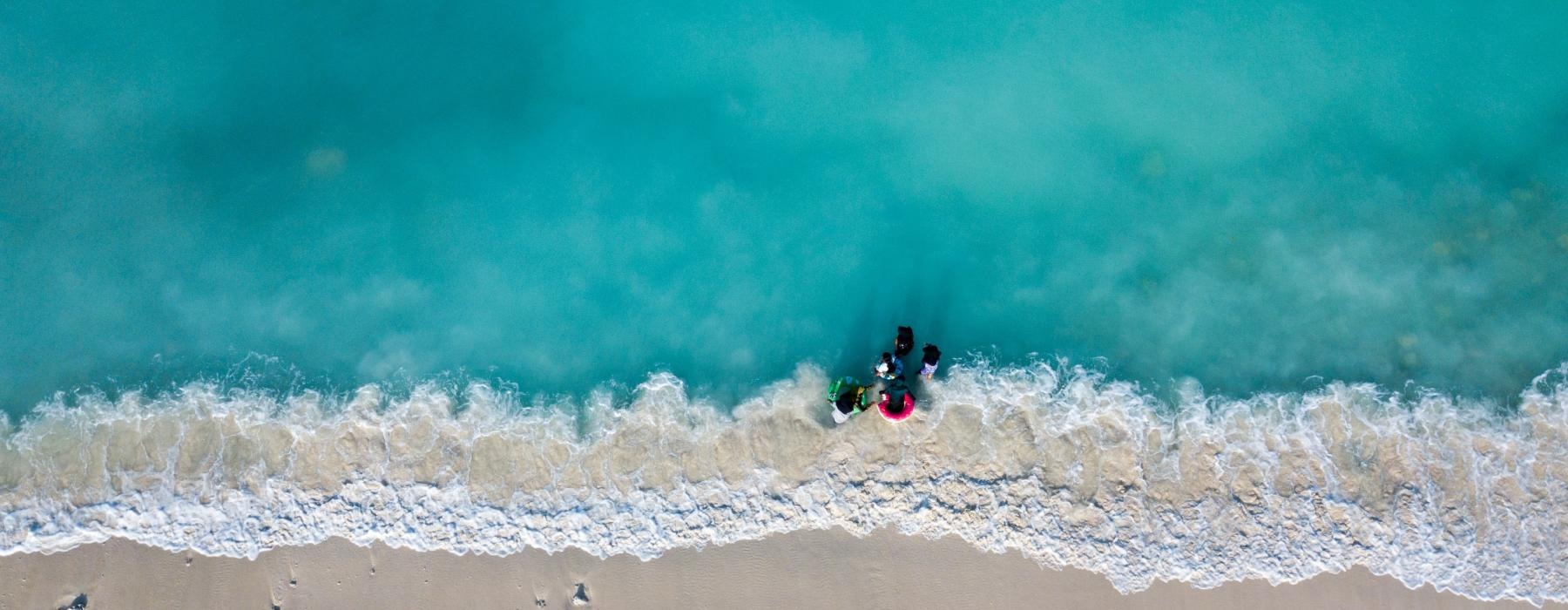 a group of people riding a wave