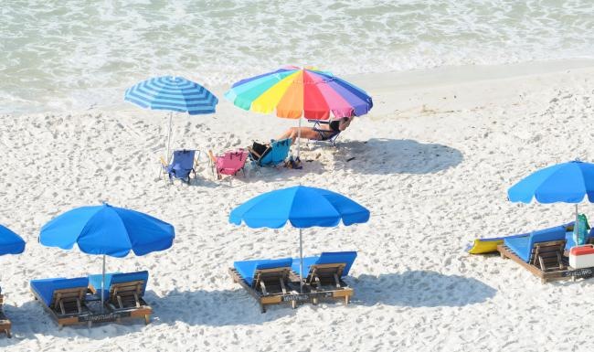 a beach with blue umbrellas