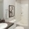 a bathroom with a white tile shower