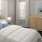 a bedroom with multiple windows