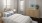 a bedroom with multiple windows