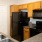 a kitchen with natural wood cabinets