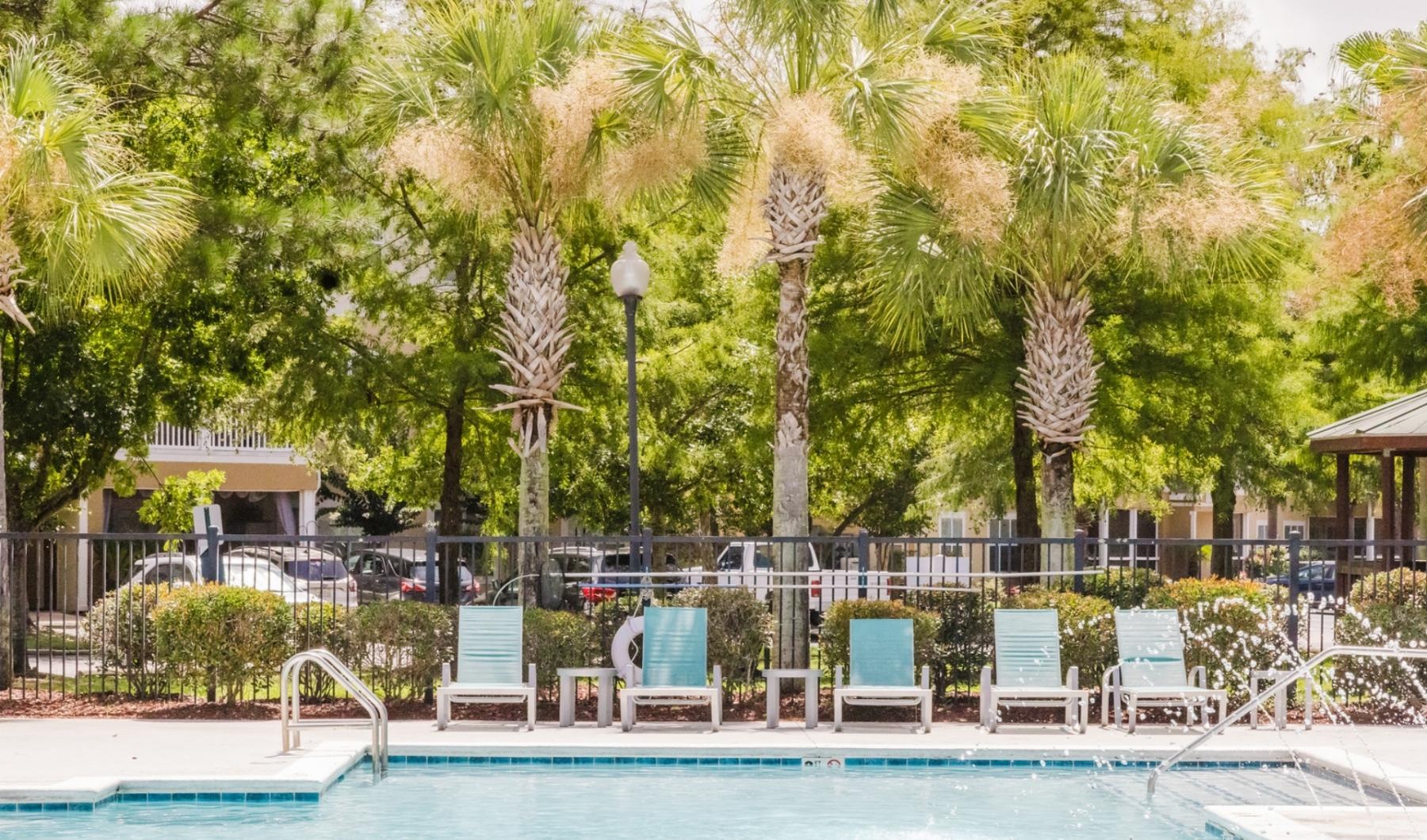 a pool with chairs around it